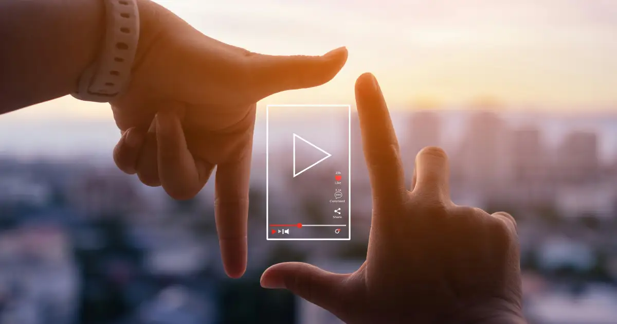 Designer building a video website with an embedded video player on a laptop