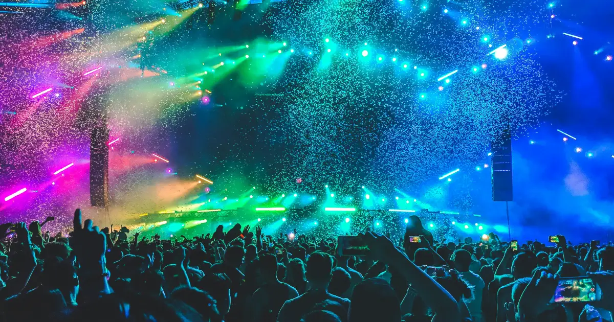 Festival audience in front of an outdoor stage at dusk