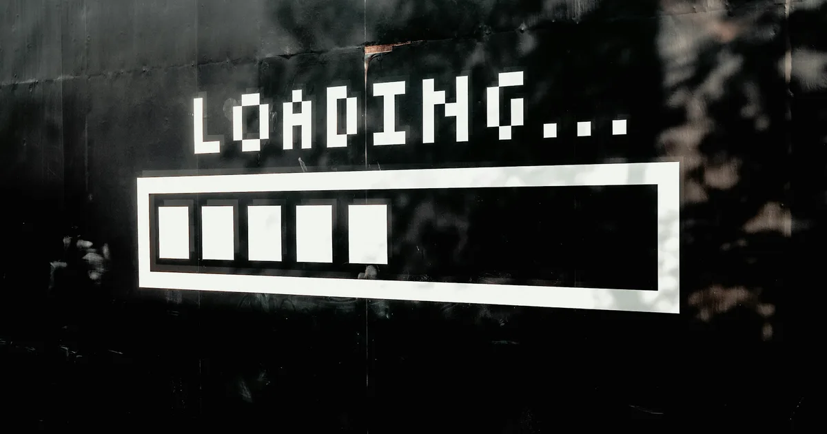 Pixel "Loading..." progress bar painted on a dark wall