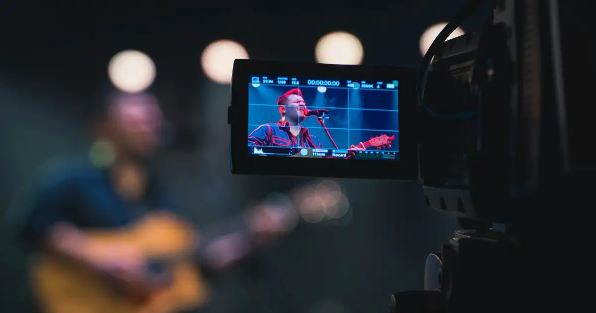 Band performing a live session in a studio with cameras around them